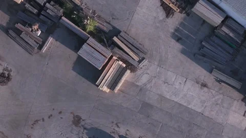 Aerial top down view of stacked lumber in an industrial yard Stock Footage 346393504