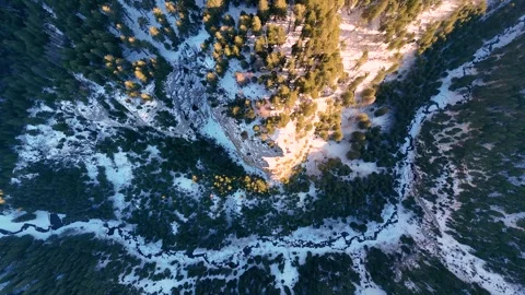 Aerial top down view of a steep rocky cliff in the winter season Video stock 296697719