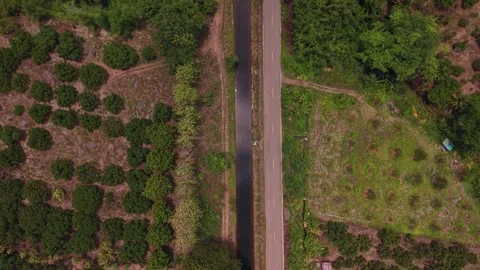 Aerial top down view of straight rural road and irrigation canal 스톡 동영상 334605418