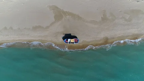 Aerial top down view of stranded refugee boat at southern mediterranean beach 4k Stock Footage 119950639