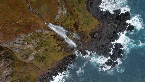 Aerial top down view of a stream of water from a cliff top in North Iceland 動画素材 117350527