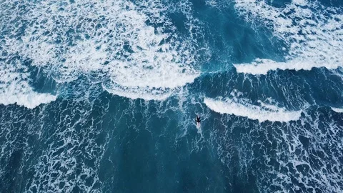 Aerial top down view of surfer with surf board in ocean wave, from drone Stock Footage 107868589