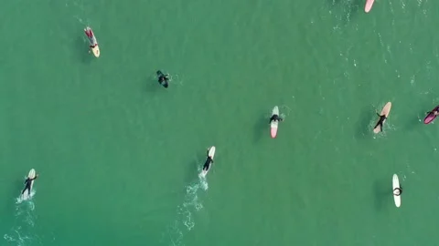 Aerial top down view of surfer trying to catch wave on longboard, Australia Video stock 133348100