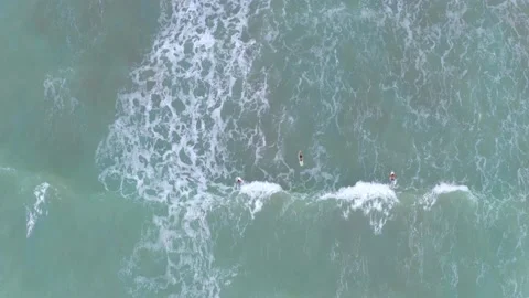 Aerial top down view of surfers catching waves Stock Footage 146754886