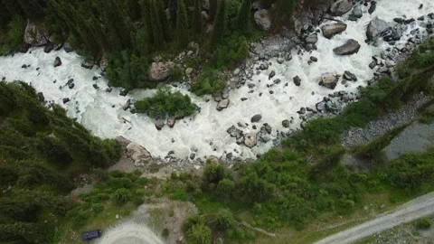 Aerial Top Down View of SUV on S-Curve Mountain Road by Rushing River Video stock 332216725