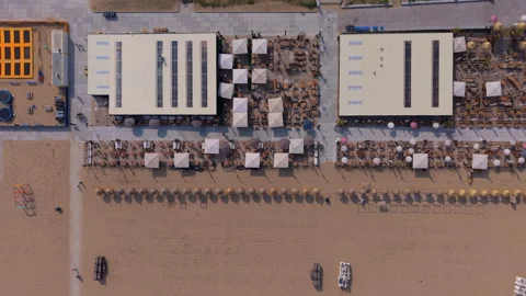 Aerial top down view of symmetrical summer beach club pavilions with large Stock Footage 340103820