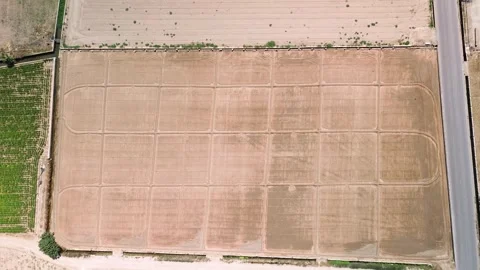 Aerial top down view of symmetrical tractor tracks on tilled soil Stock Footage 340428174