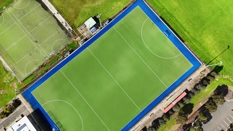 Aerial top-down view of a synthetic turf hockey pitch and a sports ground Stock Footage 345406699