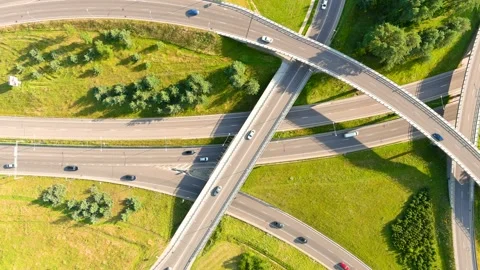 Aerial top-down view of three level road junction with traffic on sunny day, 스톡 동영상 279787754
