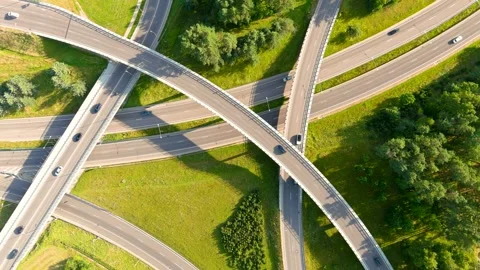 Aerial top-down view of three level road junction with traffic on sunny day, 스톡 동영상 280731147