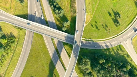 Aerial top-down view of three level road junction with traffic on summer day Stock-Footage 281458732