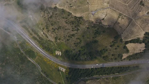 Aerial top down view through light cloud of busy road  Stock Footage 119571577