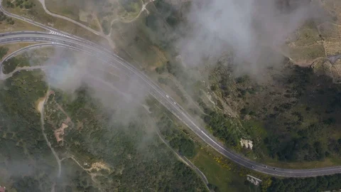 Aerial top down view through light cloud of busy road and roundabout Stock Footage 119571913
