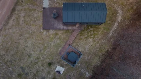 Aerial top down view of tiny house, deck, zigzag boardwalk, hot tub Stock Footage 337264742