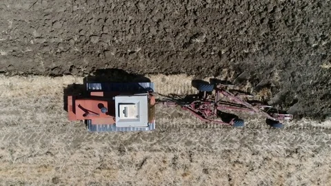 Aerial top-down view of tractor on continuous tracks plowing 4k Stock Footage 83810889
