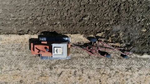 Aerial top down view of tractor on continuous tracks ploughing 4k Stock Footage 88383301