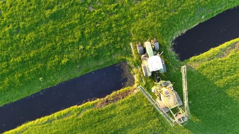 Aerial top down view of tractor going home and retracting farm implement 4k Stock Footage 101104604