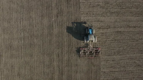 Aerial top down view of a tractor harrowing an agriculture field in spring. Stock Footage 154040552