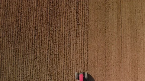 Aerial: Top Down View Of A Tractor Harrowing An Agriculture Field In Spring, Stock Footage 163179385