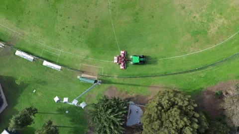 Aerial top down view of tractor mowing cricket ground grass 스톡 동영상 337810096