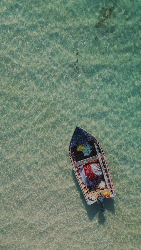 Aerial Top Down View of a Traditional Boat in Crystal Clear Turquoise Sea Stock Footage 333791281