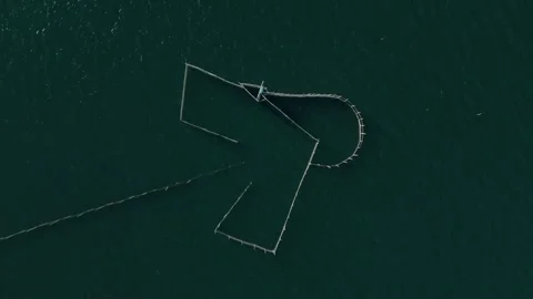 Aerial top down view of traditional fish trap structure in clear tropical waters Stock Footage 337411859