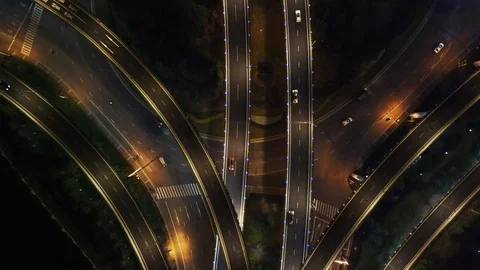 Aerial - Top Down View Of Traffic Crossing The Bridge Over Highway At Night Stock Footage 125905203