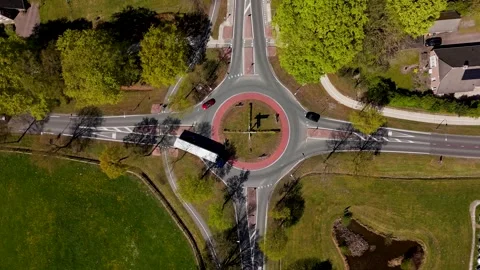 Aerial top-down view of traffic driving on a roundabout intersection Stock Footage 335064320
