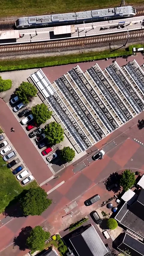Aerial top down view of a train arriving at a european station Stock Footage 336496635