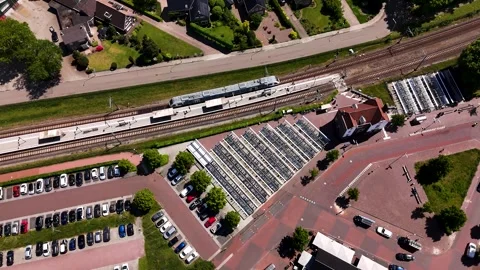 Aerial top-down view of a train arriving at a small town railway station Vídeo Stock 336594864
