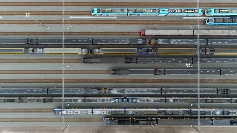 Aerial top down view of trains parked at a service station 4k Stock Footage 153368696