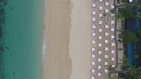 Aerial top down view of tropical beach with umbrellas Stock Footage 328925294