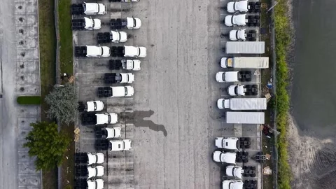 Aerial top down view of trucks moving in a parking lot 스톡 동영상 339263304
