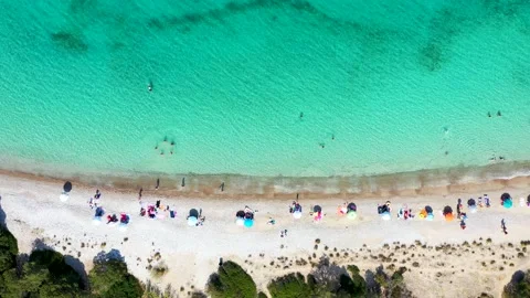 Aerial top down view to the turquoise sea of Kounoupi beach, Porto Cheli Stock Footage 155930539