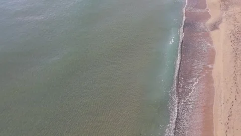 Aerial Top Down View of Turquoise Sea and Sandy Beach Stock Footage 325292349