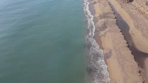 Aerial Top Down View of Turquoise Sea and Sandy Beach Stock Footage 325292352