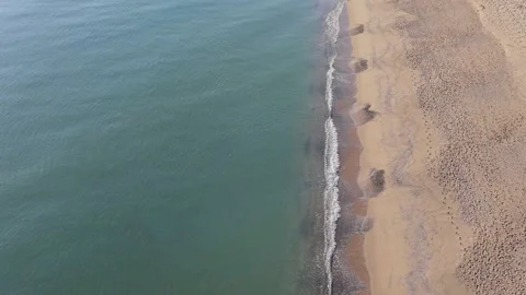 Aerial Top Down View of Turquoise Sea and Sandy Beach Stock Footage 325292381
