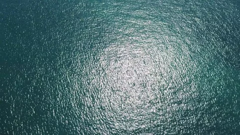 Aerial Top Down View of Turquoise Ocean Water Surface Texture with Sun Glare Video stock 344381430