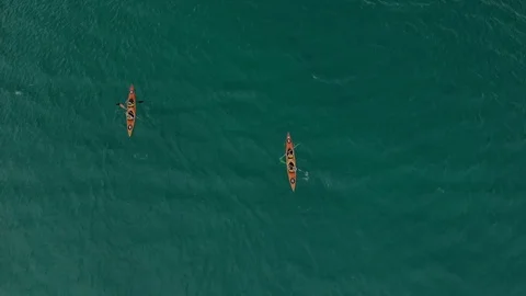 Aerial top down view two couples of kayaker paddling in lazure transparent sea Stock Footage 118619504