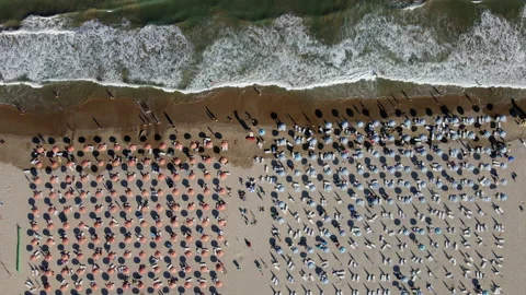 Aerial top down view of umbrellas on the beach during summer Stock Footage 148085001