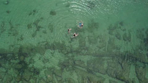 Aerial Top Down view of unidentifiable people relaxing on a turquoise water Stock Footage 241518590