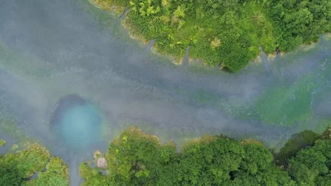 Aerial top down view of unique turquoise karst lake which has same temperature Stock Footage 251726740