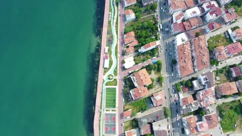 Aerial Top-Down View of Urban City Streets Meeting the Sea.  Stock Footage 320123544
