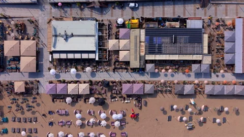 Aerial top down view of vibrant summer beach clubs and restaurant terraces Stock Footage 340041537