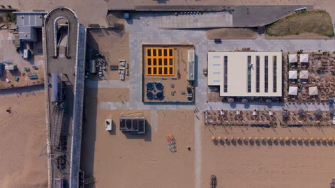 Aerial top down view of a vibrant summer beach club with outdoor trampoline Stock Footage 340041801