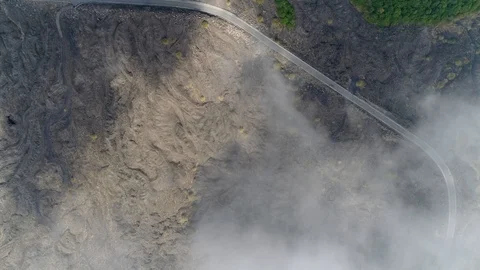 Aerial top down view of volcanic landscape first showing thick clouds 4k Stock Footage 89292155