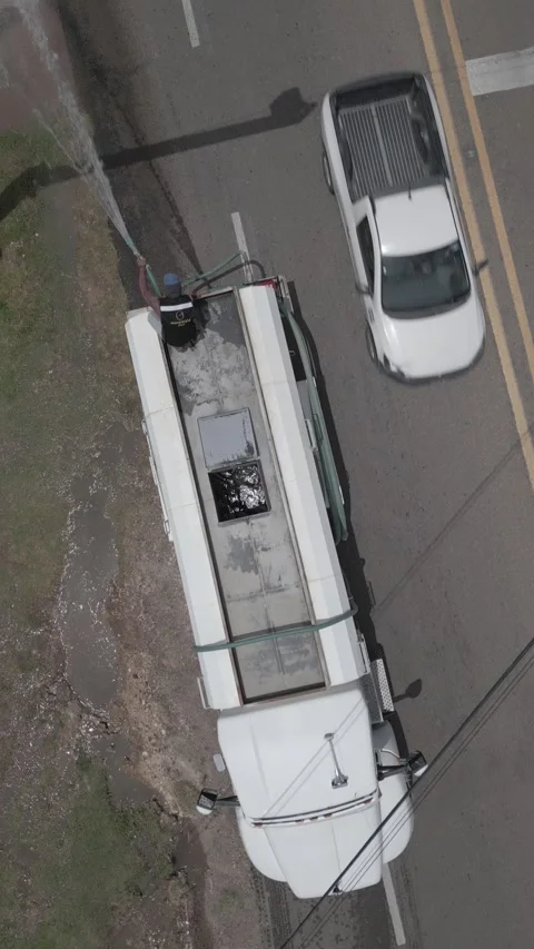 Aerial top down view of a water delivery tanker truck moving along a road Stock-Footage 341549214