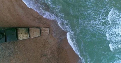 Aerial top down view of waves on the beach in Brighton Stock Footage 78310045
