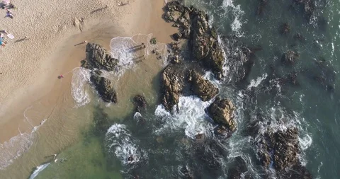 Aerial Top Down View of Waves Crashing on Rocks Stock Footage 103735269