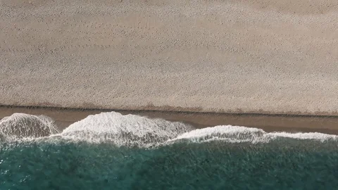 Aerial top down view of waves crashing on a beach in the Mediterranean sea Stock Footage 119206492